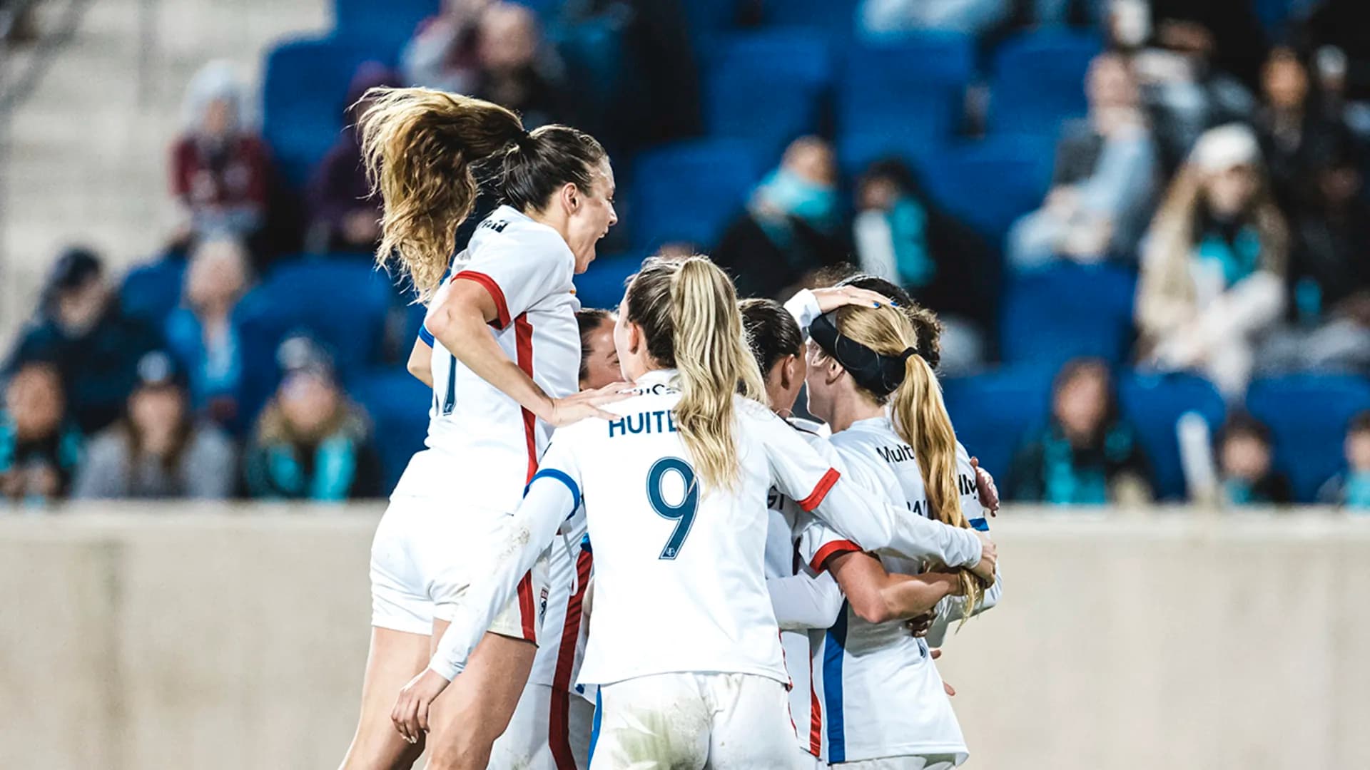 ol-reign-players-celebrate-a-goal-against-gotham